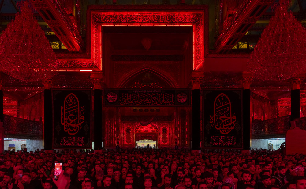 Pilgrims in the illuminated interior of a shrine
